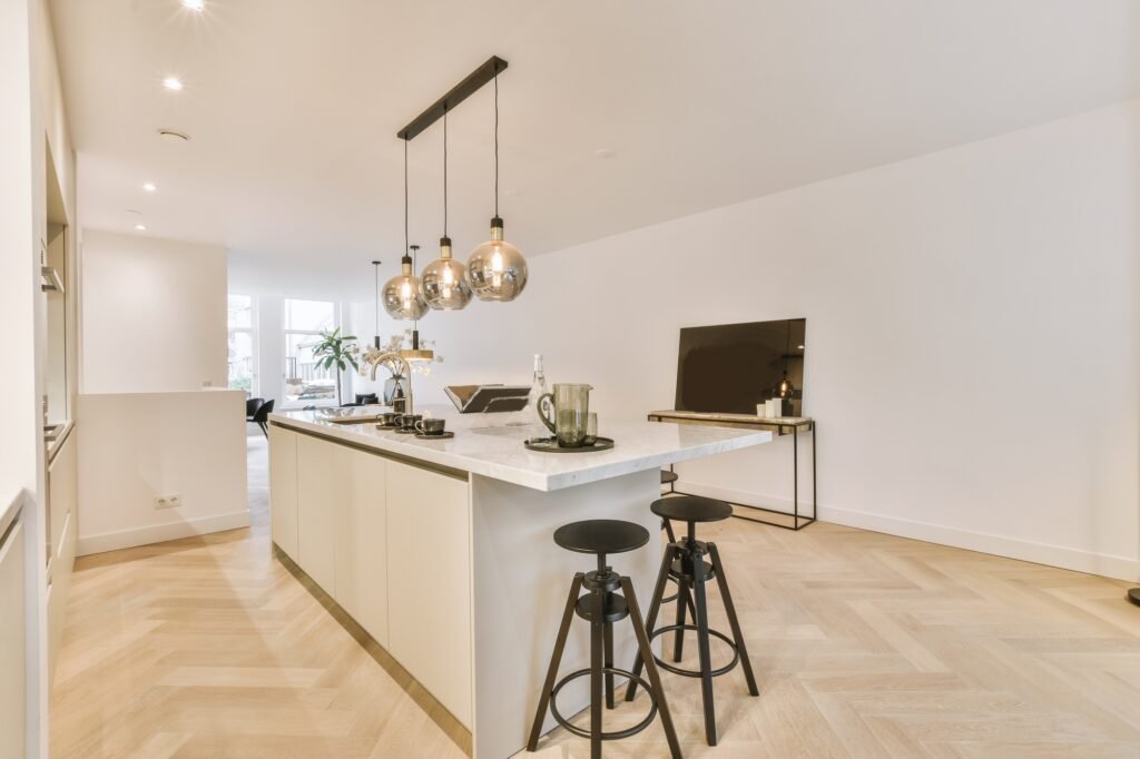 Elegant kitchen design with pendant lamps Spacious open plan kitchen and living room